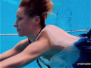 redhead babe swimming nude in the pool